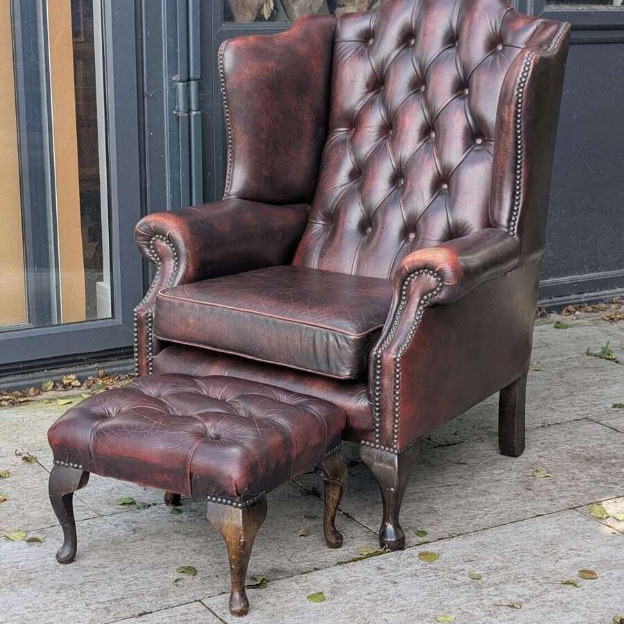 Vintage oxblood red leather Chesterfield wingback armchair with matching footstool