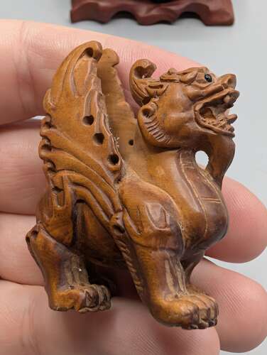 Japanese boxwood carved netsuke group of three, kirin, teapot & foot with hardwood stand