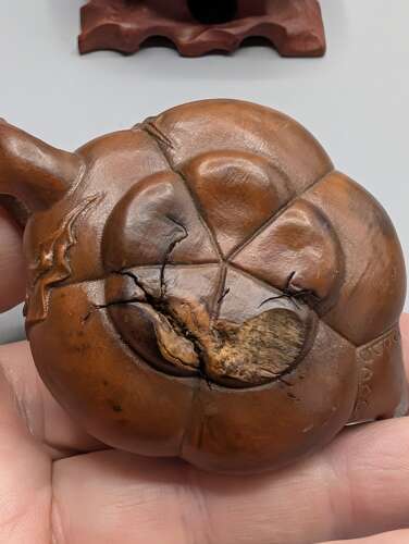 Japanese boxwood carved netsuke group of three, kirin, teapot & foot with hardwood stand