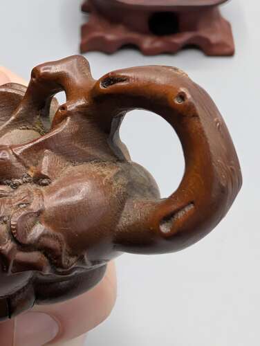 Japanese boxwood carved netsuke group of three, kirin, teapot & foot with hardwood stand