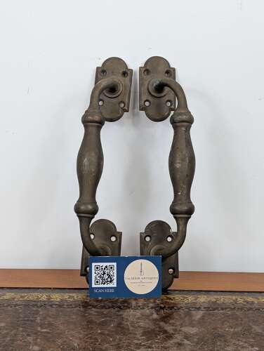 Pair of brass door pull handles with shaped backplates early 20th century